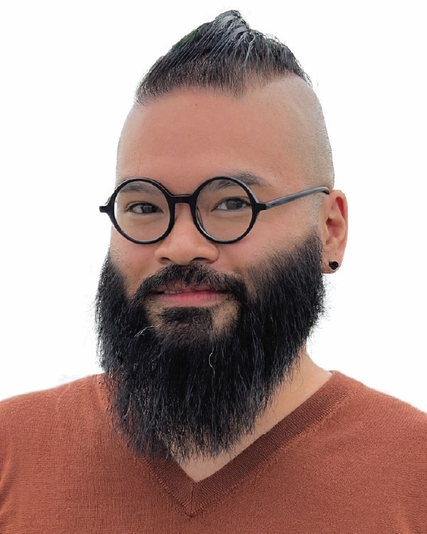 Person with glasses and beard smiling slightly.