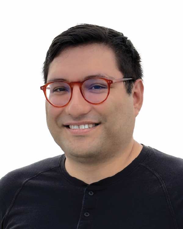 Smiling person with red glasses on white background.