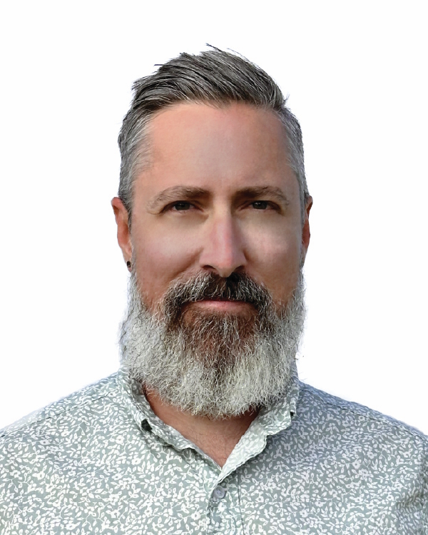 Man with gray beard and patterned shirt.